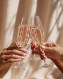 two champagen glasses clinking to represent the blog post " How to Stop Losing Yourself in Relationships"